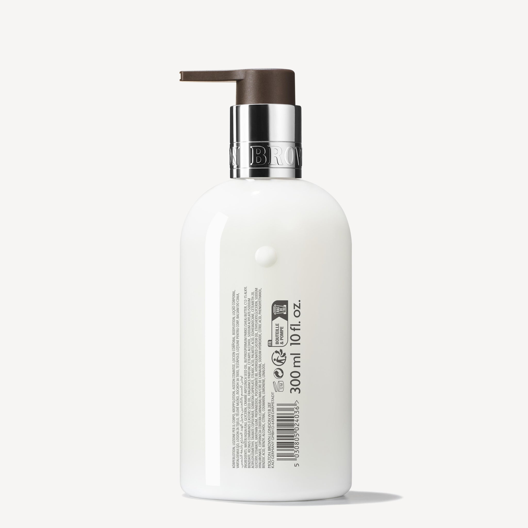 A white bottle with a brown pump, silver collar, and side label in black print and barcode, showcasing Sunlit Clementine & Vetiver Body Lotion—hydrating formula—300 ml (10 fl. oz.).