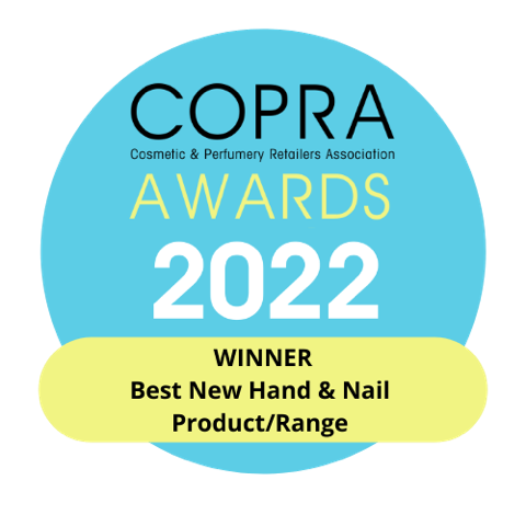 A blue circular COPRA Awards 2022 badge with yellow text: WINNER Best New Hand & Nail Product/Range. COPRA stands for Cosmetic & Perfumery Retailers Association. Flora Luminare Fine Liquid Hand Wash 300ml recognized for vegan innovation.