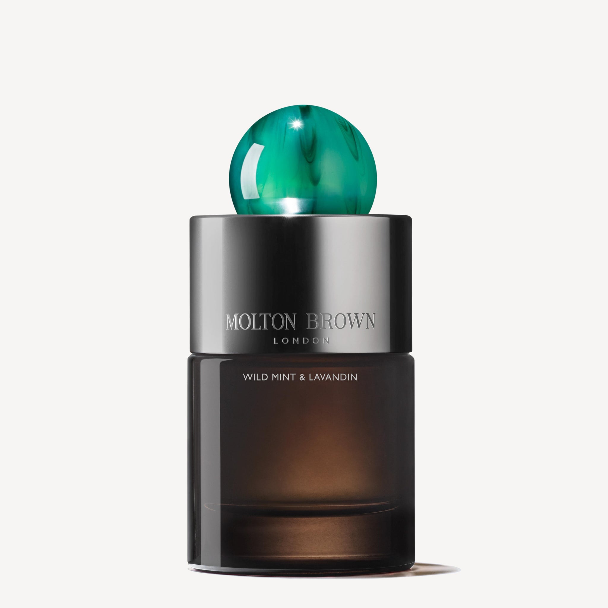 A sleek Wild Mint & Lavandin Eau de Parfum 100ml bottle by Molton Brown London, with a dark brown body, metallic silver band, and a round green marbled cap.